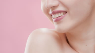 Female beauty model moves her shoulder smiling wide for camera
