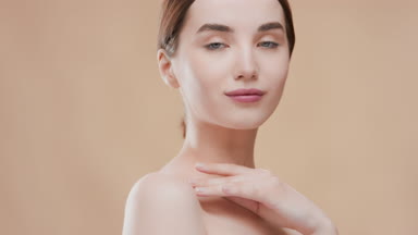 Fit Caucasian skincare woman touches collar bones turning body