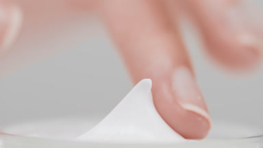 Skincare woman takes face care cream with her finger from can