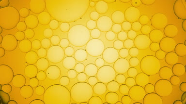 Big clear bubble moves along yellow smaller ones and explodes