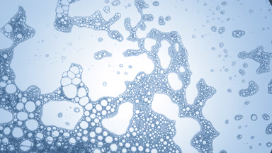 A lot of clear different sized bubbles move in dark blue fluid