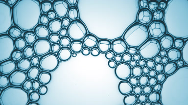 Clear different sized bubbles burst spontaneously at a time