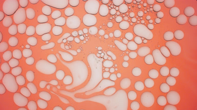 Pale grey stretched bubbles slowly return to their usual shape