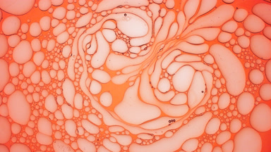 Stretched light red bubbles slowly return to their usual shape