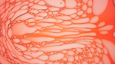 Light pink bubbles move in circles slowly and endlessly
