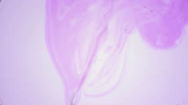 Purple liquid with tiny bubbles is injected into pale violet one