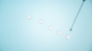 Pale grey drops is dripped from syringe on transparent fluid