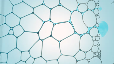 Cyan liquid flows between transparent bubbles making them move