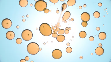 Oily fluid is injected into clear one with yellow clear bubbles