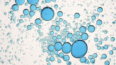 Blue different sized clear bubbles move to the center shaking