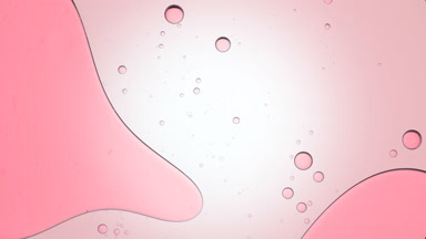 Pink bubble moves to the left in clear fluid with smaller ones