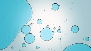 Blue bubble moves to the left in clear liquid with smaller ones