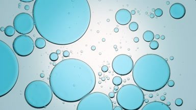 Big blue transparent bubbles move slowly from the center