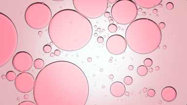 Pink bubbles move slowly and spontaneously in clear fluid