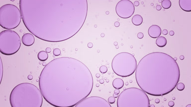 Big purple clear bubbles move slowly from the center in fluid