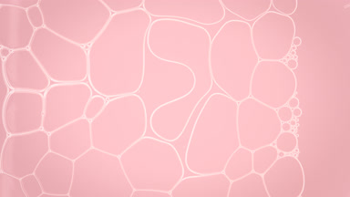 Liquid flows between white soap bubbles making them move