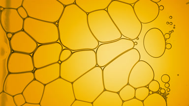 Clear fluid flows between transparent bubbles making them move