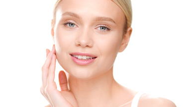 Fit woman touches jaw line turning head to the camera and smiles