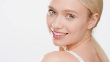 Attractive European young woman turns to the camera smiling wide