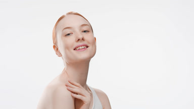 Pretty Caucasian redhead woman smiles wide touching shoulder