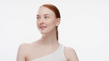Cute fit red head woman in white top smiles wide for the camera