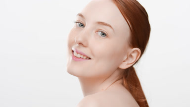 Attractive slim European young woman turns to the camera smiling