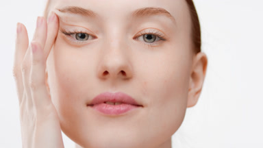 Beautiful European woman smiles for the camera stretching skin