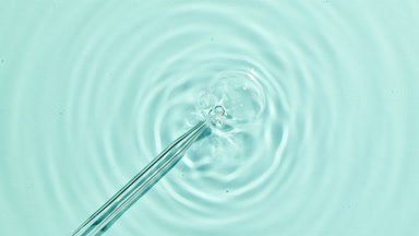 Air bubbles comes from chemical dropper on green mint background