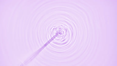 Fluid is injected from syringe creating bubbles and circles