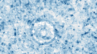 Drop making water rings on surface over blue crystal minerals