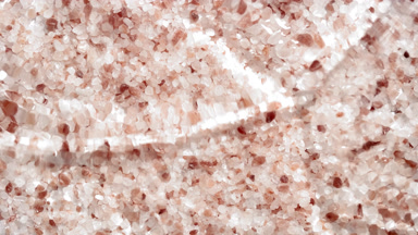 Water waves crossing and splashing over brown mineral crystals