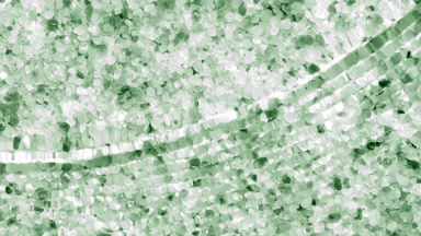 Water waves crossing and splashing over green mineral crystals