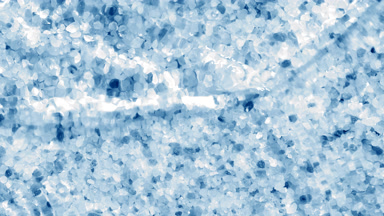 Water surface with waves and ripples on blue salt background