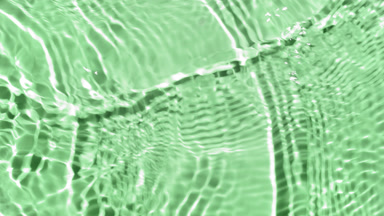 Water waves crossing and splashing against green background