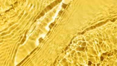 Water waves and ripples crossing on yellow background