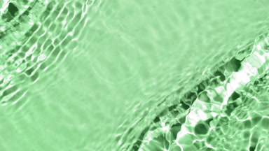 Water waves and ripples crossing against green background
