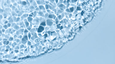 Wave making ripples on water surface on blue background