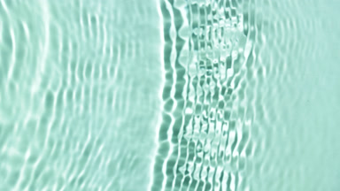 Single wave making ripples and splashes on green mint background