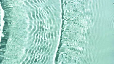 Multiple waves makes ripples on surface on green mint background