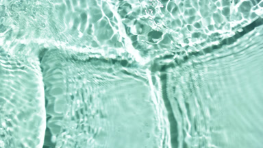 Water waves crossing and splashing against green mint background