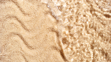 Water flows from the top of handful of brown sugar flooding it