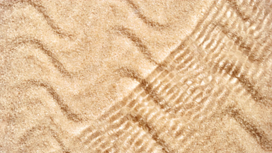 Wave making ripples on water surface on brown sugar background
