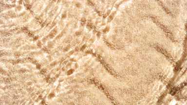 Multiple waves of water cross each other creating ripples