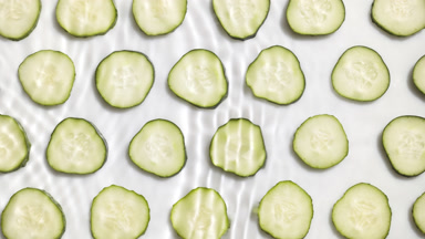 Waves makes ripples on water surface over cucumber rings