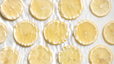 Wave flowing on surface making ripples over lemon slices