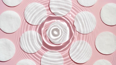 Drop falls down on water surface creating concentric circles