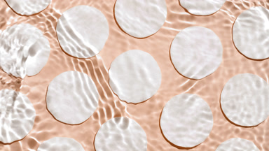 Water ripples and waves over cotton pads on beige bg