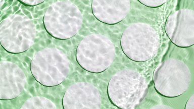 Multiple waves of water create ripples on green background