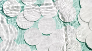 Waves cross each other creating ripples on pale green background