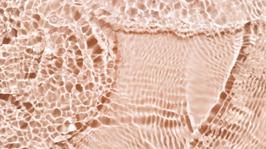 Water waves crossing and splashing on beige bg
